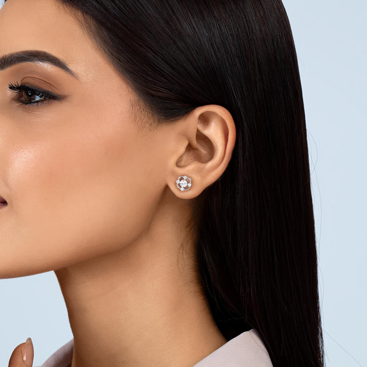 14K white gold lab-grown diamond stud earring with a round center diamond and four accent diamonds in an open floral setting.