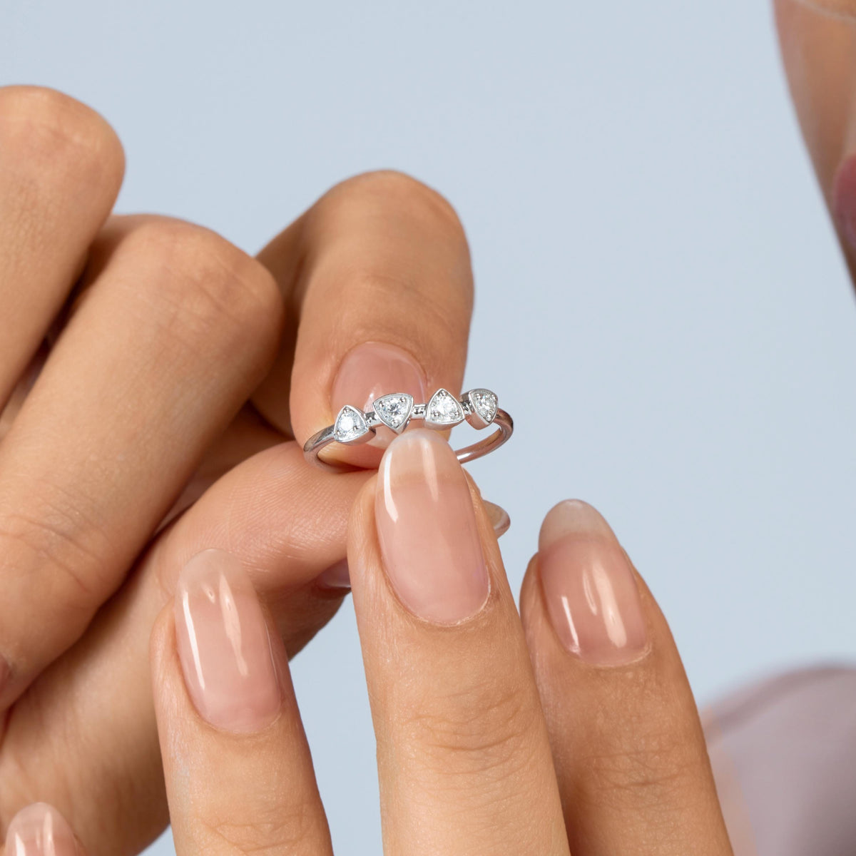 14K white gold four-stone ring with 0.10 CTW round lab-grown diamonds in shield-shaped settings, shown in close-up.