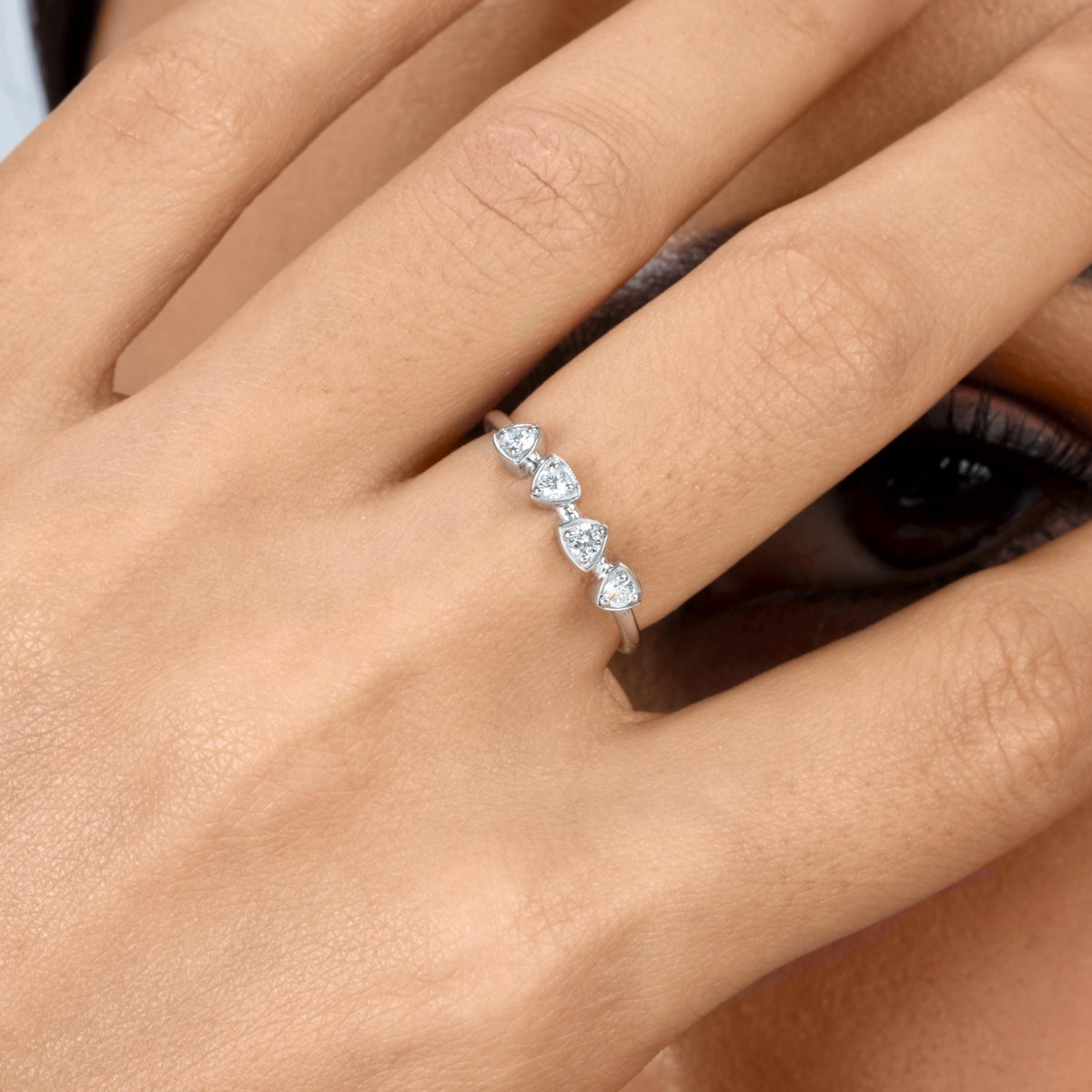 Four-stone lab-grown diamond ring in 14K white gold with shield-shaped settings and a slim band, worn on a finger.