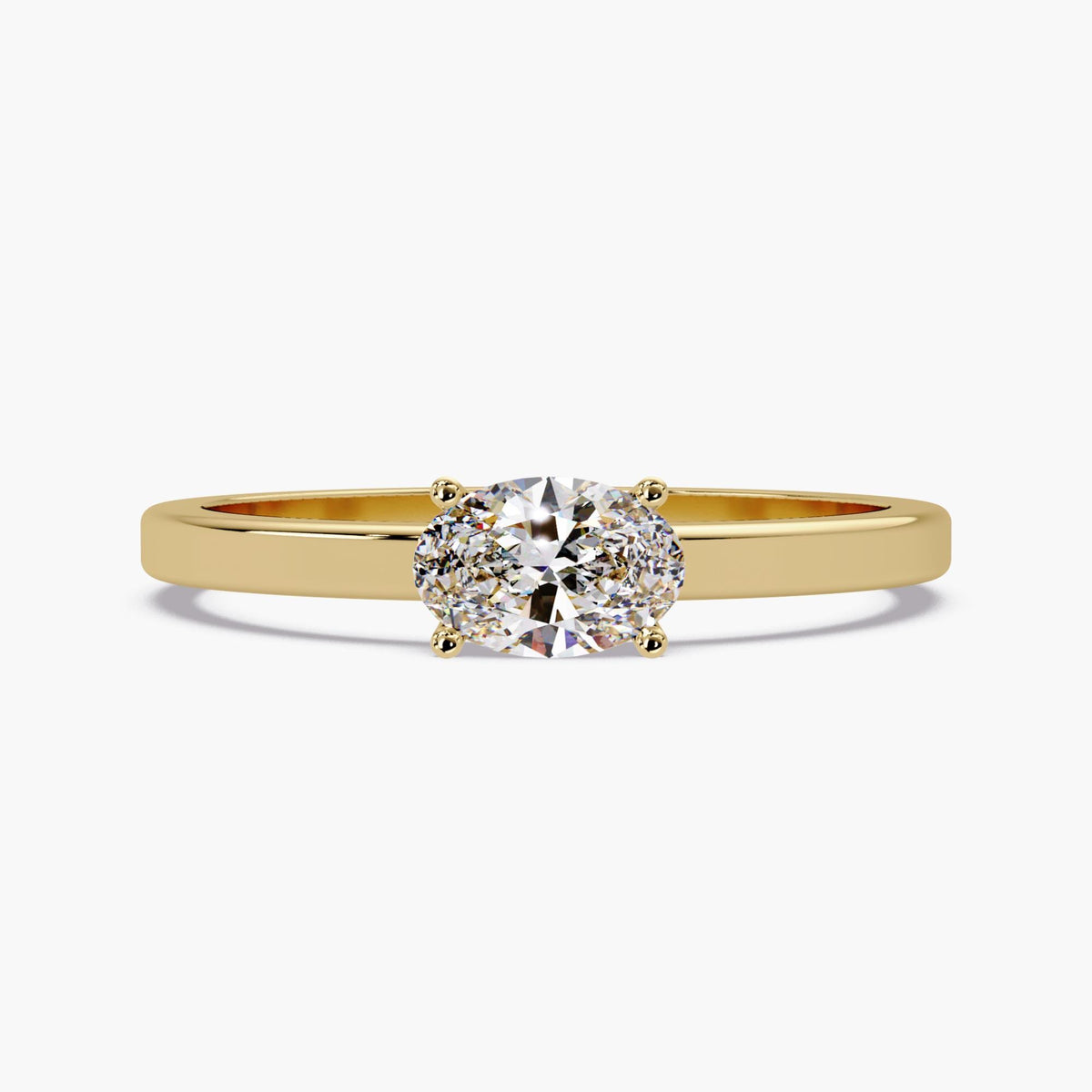 A 14K yellow gold solitaire ring with one 6 × 4 mm oval lab-grown diamond secured by four prongs on a slim polished band.