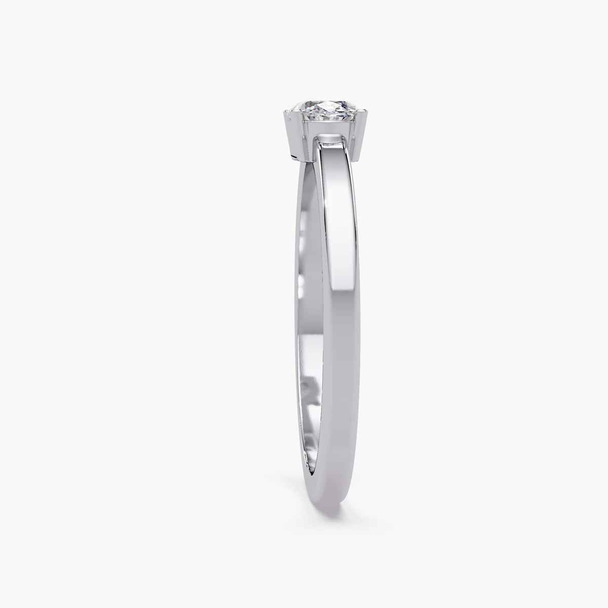 The 14K white gold ring shown from the side, highlighting the oval diamond’s four-prong basket and slim band profile.