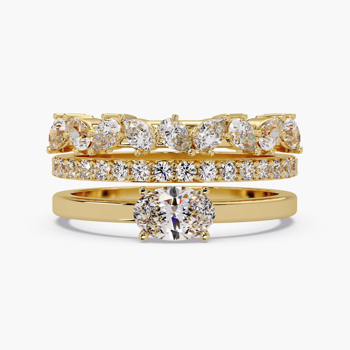The oval lab-grown diamond solitaire placed beneath two coordinating diamond bands for styling inspiration; the additional bands are not included.