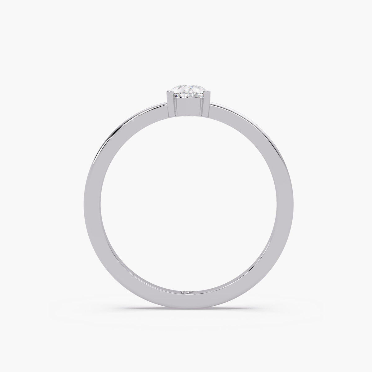 The pear solitaire ring shown from behind, revealing the open space beneath the center diamond and the polished 14K white gold shank.