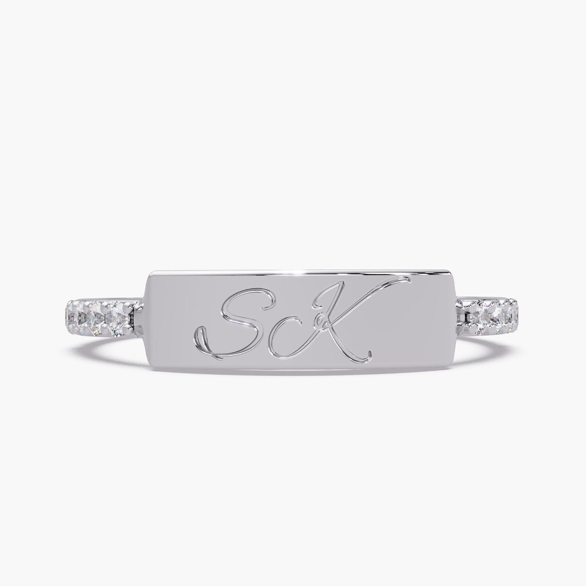 Custom double initial ring in 14K white gold with script S and K engraving and lab-grown diamond accents.