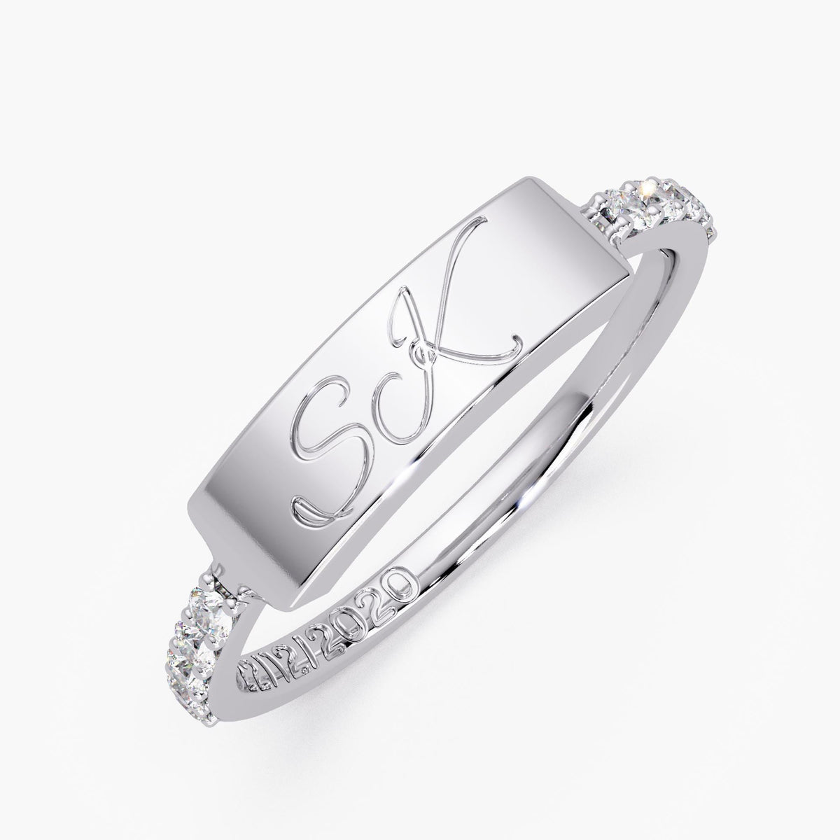 Personalized white gold two-letter diamond ring with script initials and a custom engraved date inside the band.