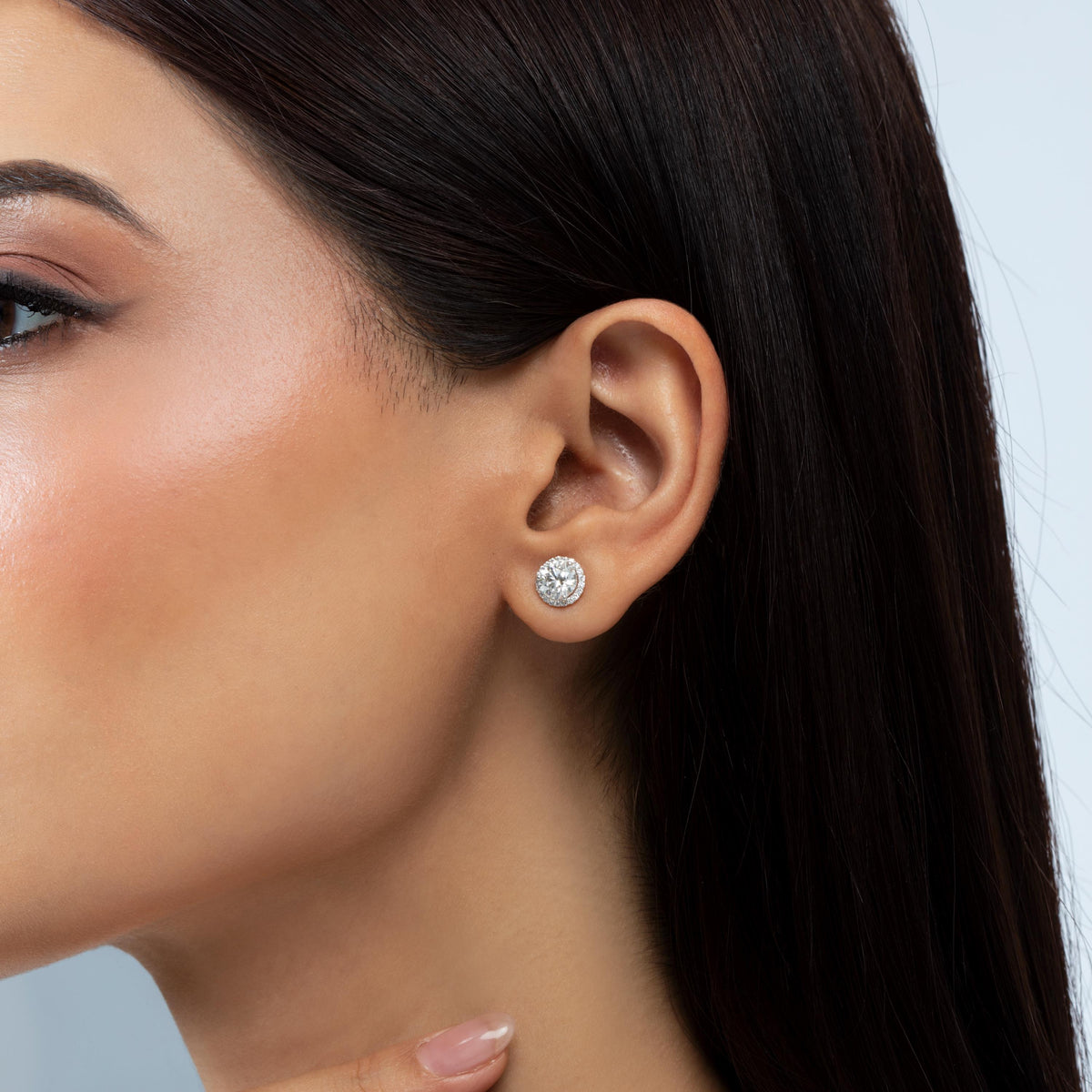 14K gold round brilliant lab-grown diamond cluster stud earring worn on an ear.