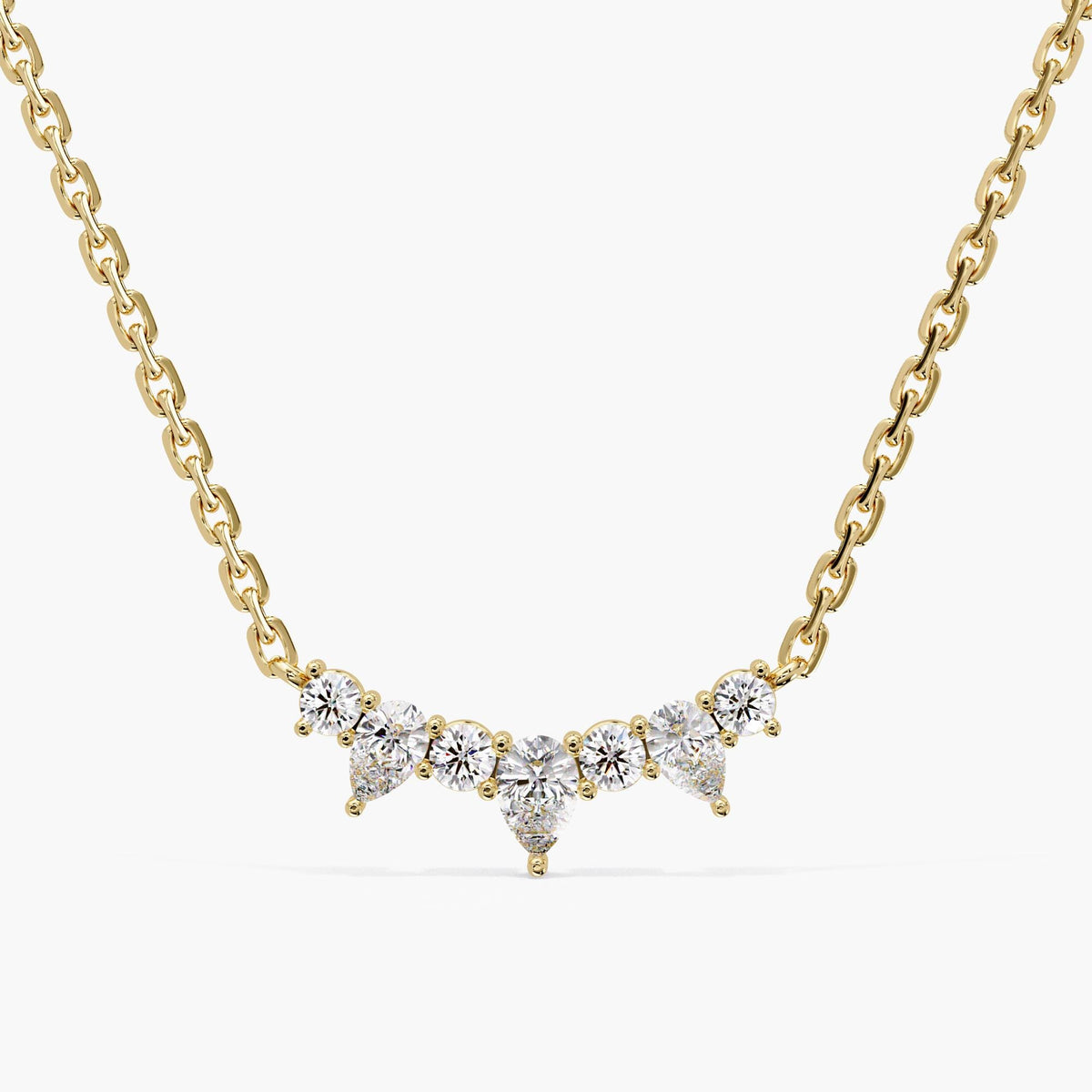 14K yellow gold curved bar necklace with seven pear and round lab-grown diamonds totaling 1.25 CTW