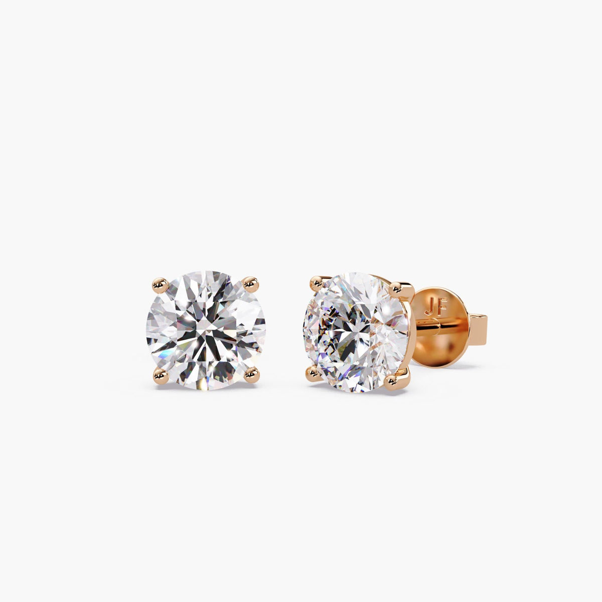 Round lab-grown diamond stud earrings in 14K rose gold with four-prong settings and secure push-back closures.