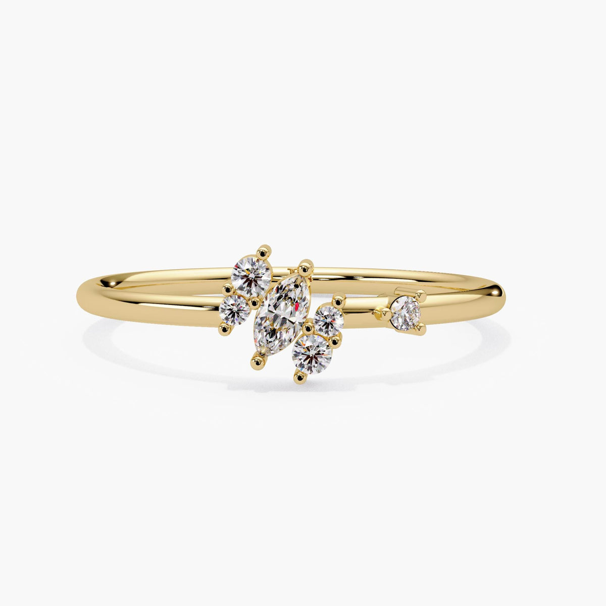 14k yellow gold marquise diamond cluster ring shown at an angle, with one marquise lab grown diamond centered between five graduated round diamonds on a thin gold band.