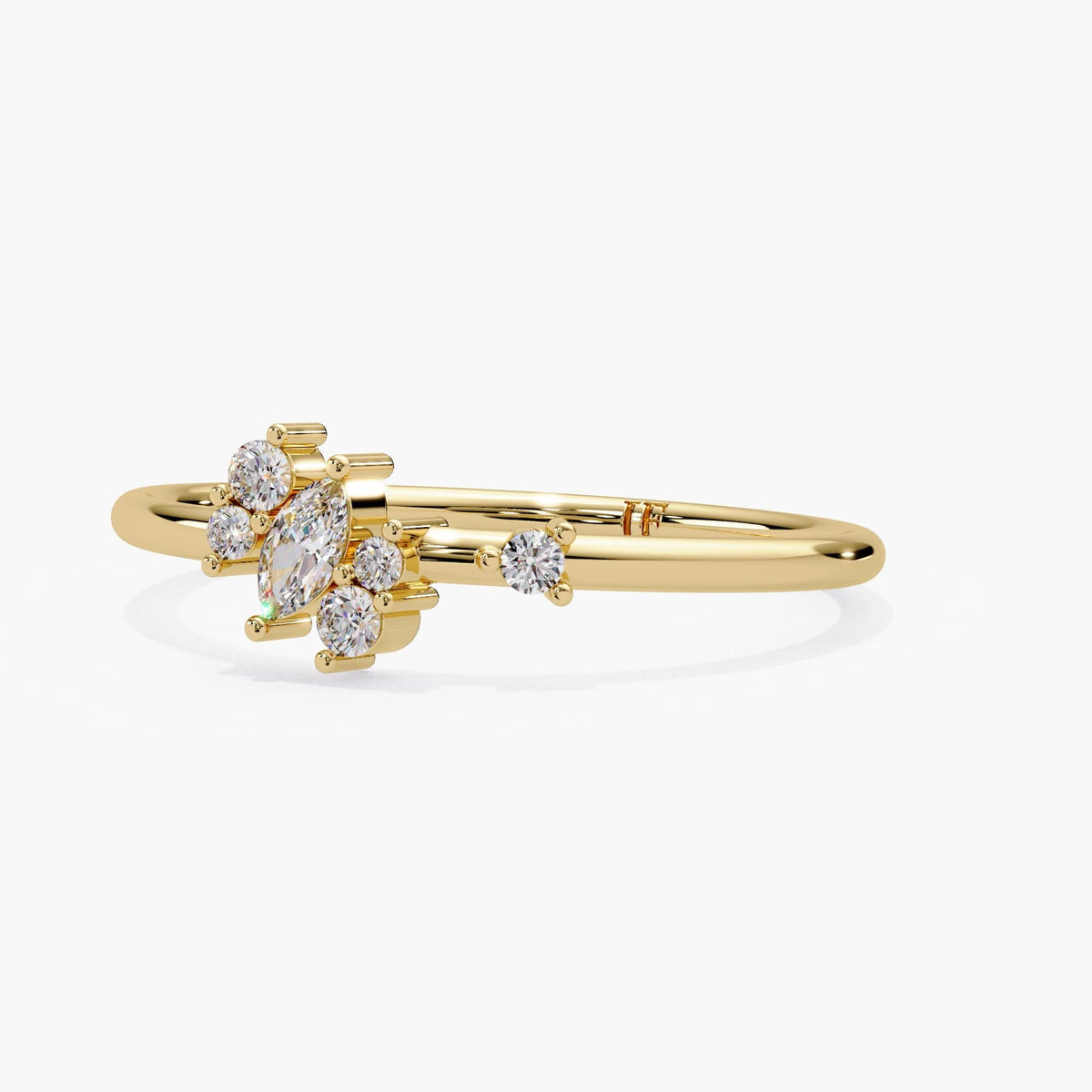 marquise and round diamond cluster in 14k yellow gold, showing the graduated stone layout and prong and bar settings.