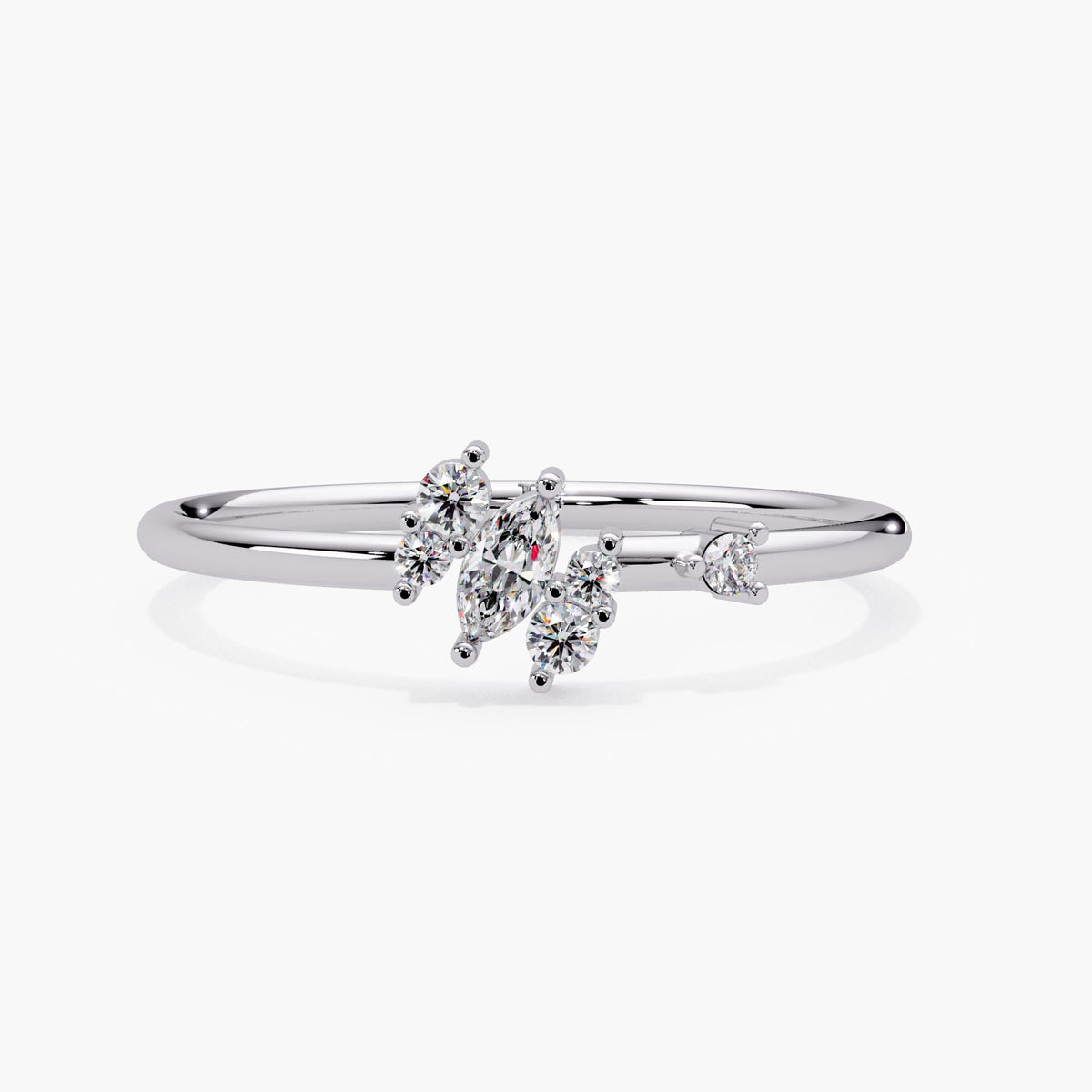 14k white gold marquise diamond cluster ring at an angle, with lab grown diamonds set in a graduated cluster on a dainty band.