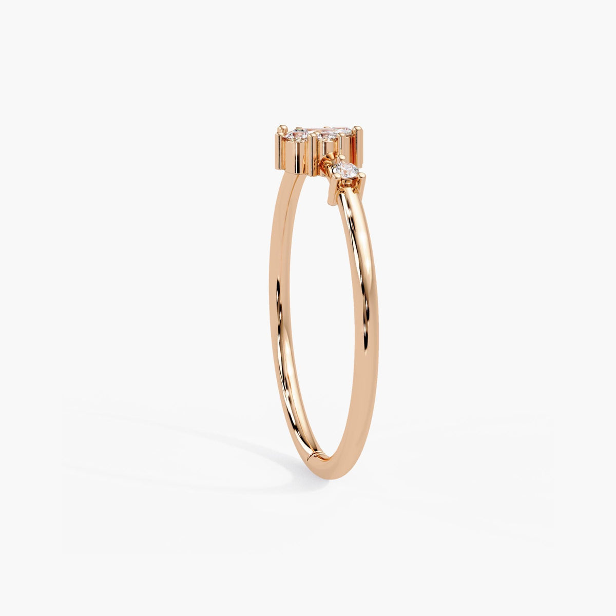 14k rose gold cluster ring standing upright, showing the slim band and low profile of the diamond cluster.