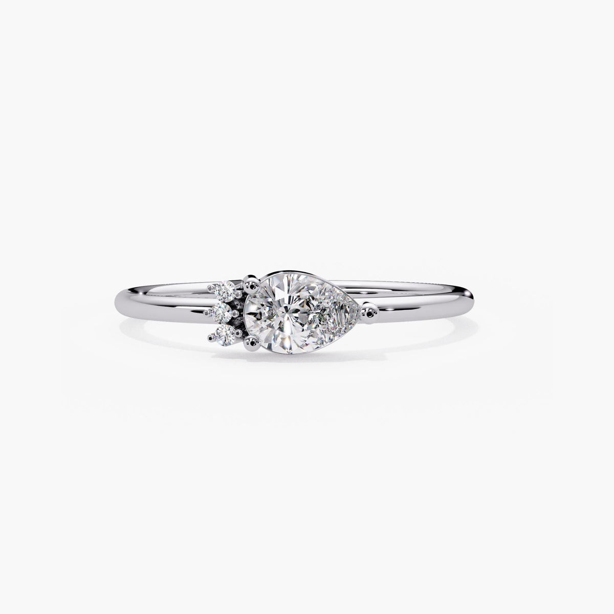 14k white gold east west pear diamond ring with a horizontal teardrop center and three round side accents.