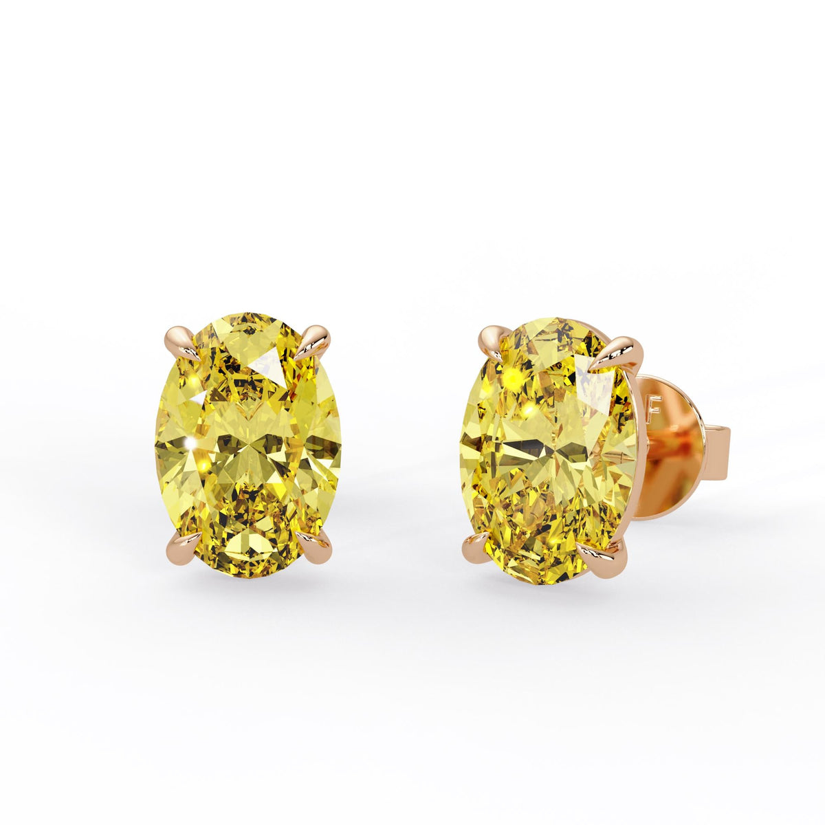 Oval fancy intense yellow lab grown diamond stud earrings in 14K rose gold with four claw prongs and pushback closures.