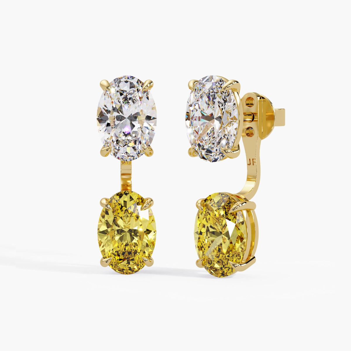 Yellow diamond earring jackets paired with white oval diamond studs / yellow gold / two-stone combination