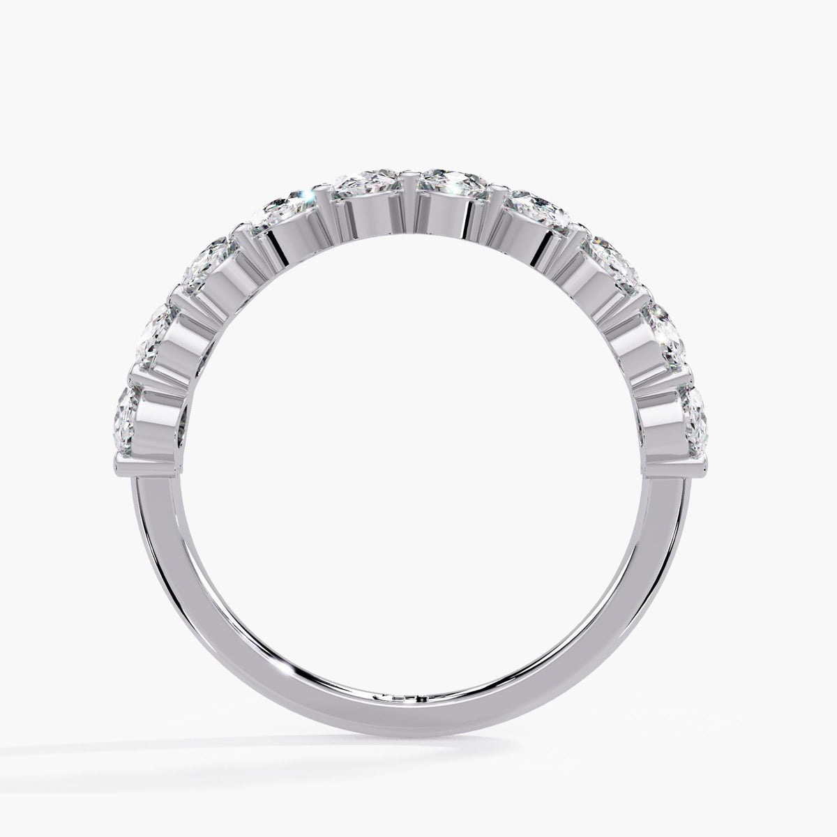 Low setting oval diamond half eternity band in 14K white gold, showing the shared prong baskets and smooth lower band.