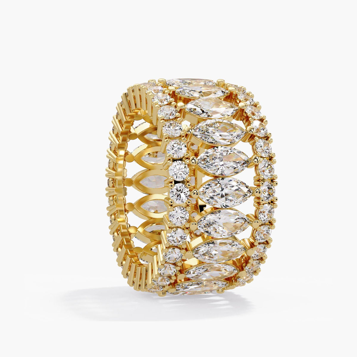Wide pavé diamond band in 14K yellow gold, tilted to show marquise diamonds between round diamond borders, polished prongs and the open gold structure inside the ring.