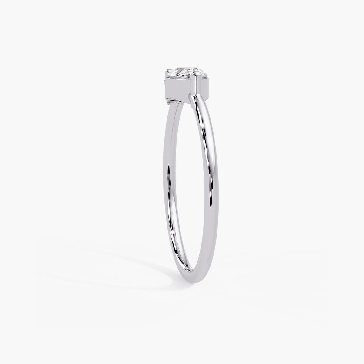 Dainty 14k white gold pear cut ring with a slim band and a low profile east west setting.