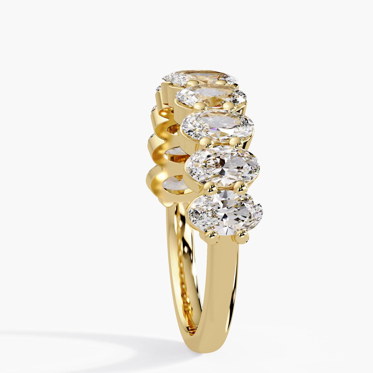 Oval lab grown diamond ring in 14K yellow gold, showing the prong setting, open diamond baskets, and polished 2 mm shank.