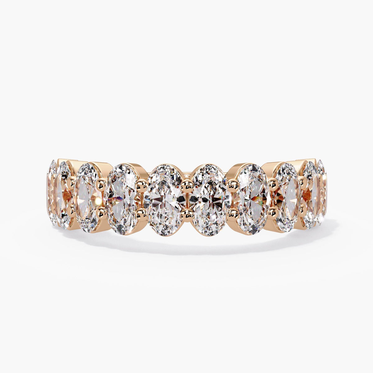 14K rose gold lab made diamond wedding ring with ten oval diamonds, a low setting, and shared prongs.