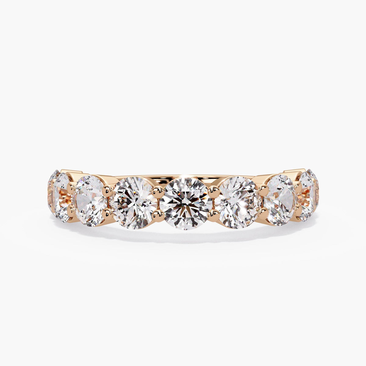 Round anniversary band in 14K rose gold with nine lab grown diamonds, shared prongs, and a low setting