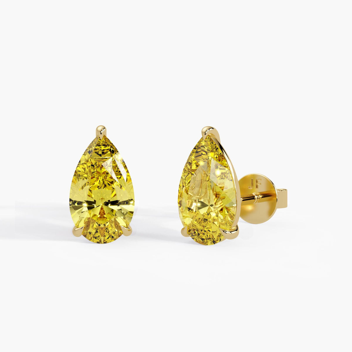 Fancy intense yellow pear lab grown diamond stud earrings in 14K yellow gold with claw prong setting