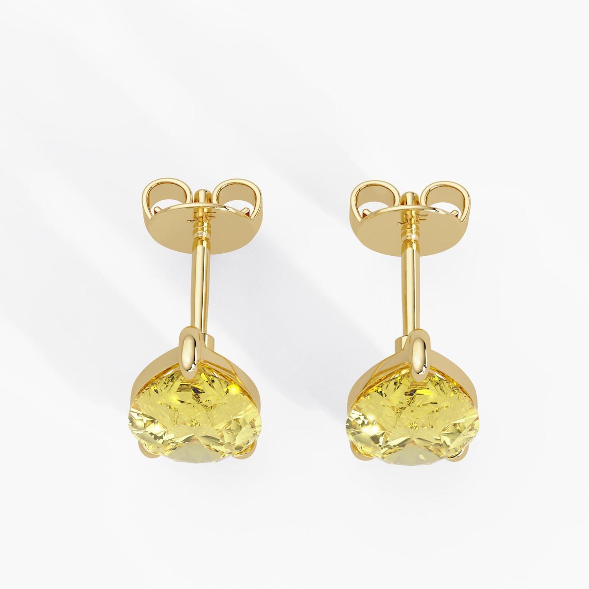 Pear cut yellow lab diamond stud earrings in 14K yellow gold with push back closure