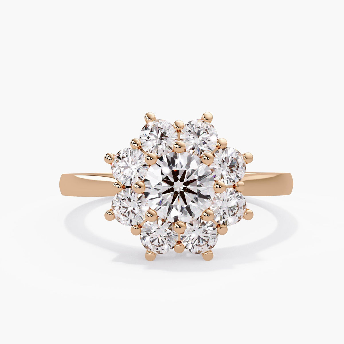 Rose gold lab grown ring with a round brilliant diamond center and eight diamond petals, forming a flower halo on a polished 14K rose gold band.