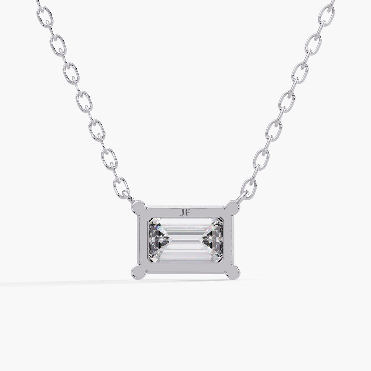 east west emerald cut necklace / solid white gold pendant / open-backed diamond setting / cable chain attachments / rear view