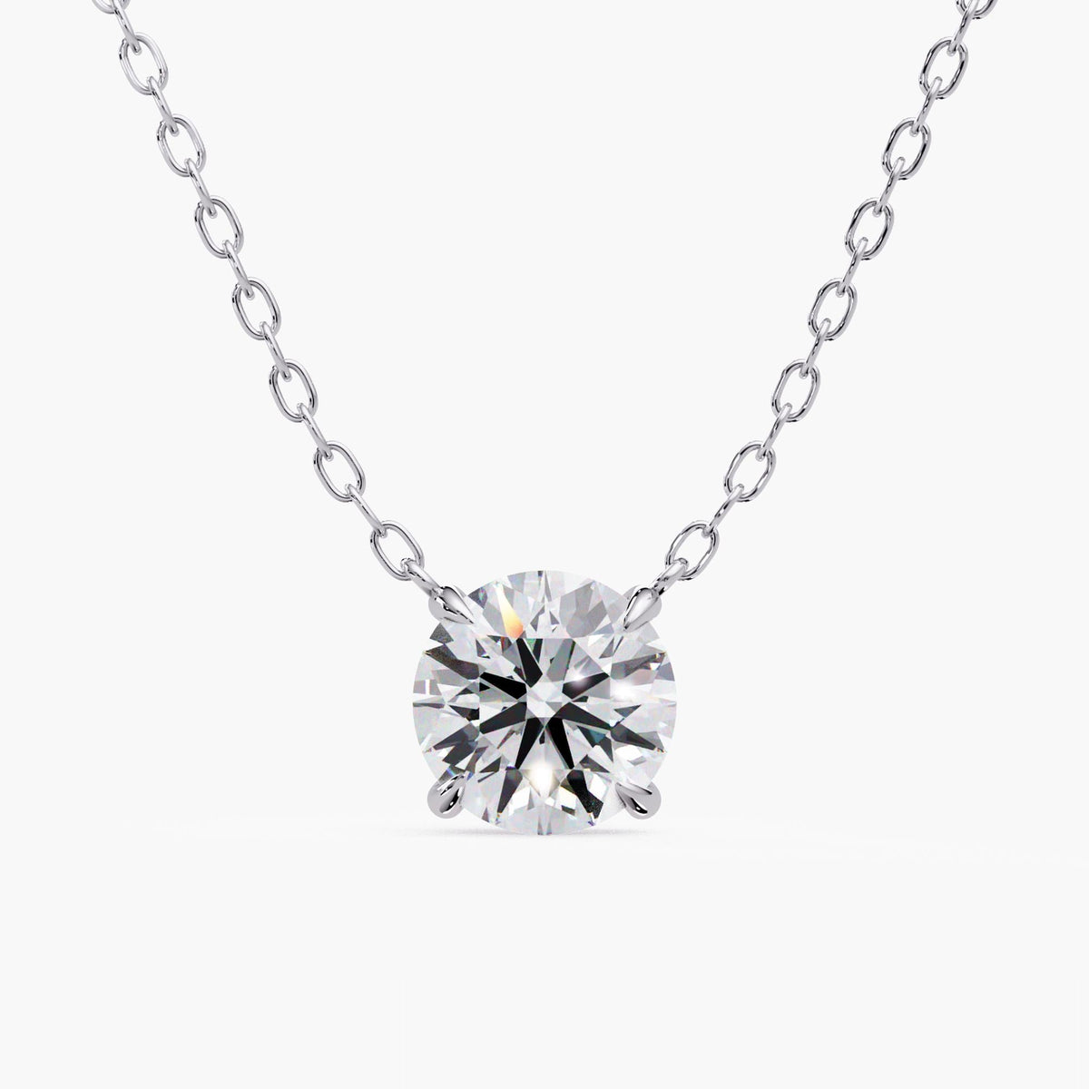 Round lab-grown diamond solitaire pendant necklace in 14K white gold, featuring a four-prong setting and delicate cable chain