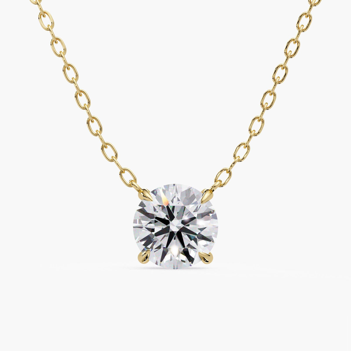 Round lab-grown diamond solitaire pendant necklace in 14K yellow gold, featuring a four-prong setting and delicate cable chain